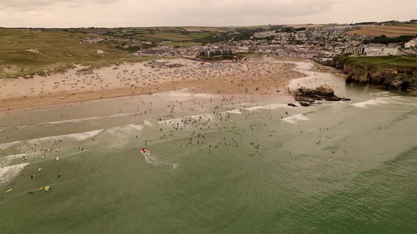 Perranporth Beach Packed Full Of Summer Surfers and Holiday Makers Cornwall UK Aerial View