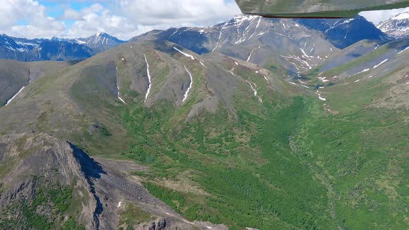 Small airplane flight over alpine ridges, Talkeetna Range, west of Palmer Alaska.