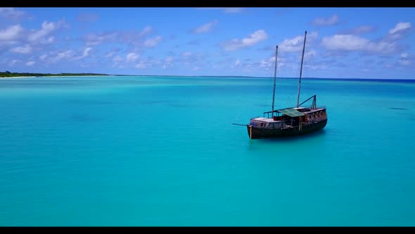 Aerial landscape of perfect tourist beach lifestyle by blue sea with white sandy background of a day