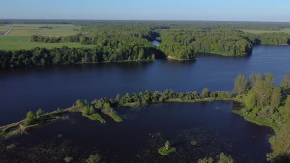 AERIAL Fly-By over a Forested River Landscape in Lithuania