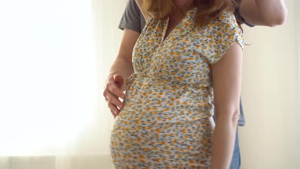 Pregnant Woman and Her Husband Holding Hand Together