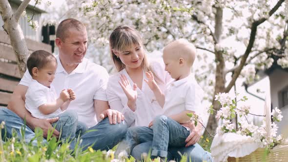 Parents with Two Little Sons Spending Time in Village