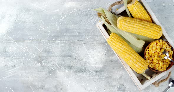 Male Hand with a Spoon Takes the Corn From the Plate and Puts It on the Table. 