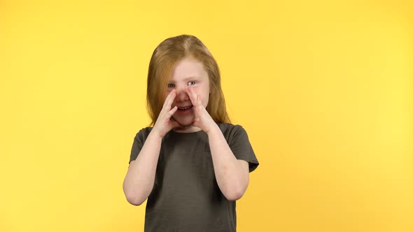 Red-haired Child Screaming Putting His Hands To His Face