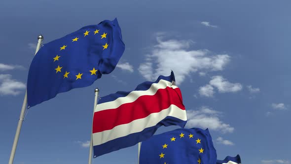 Waving Flags of Costa Rica and the EU on Sky Background