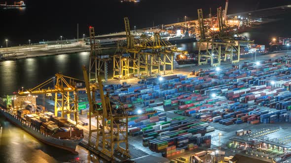 Seaport and Loading Docks at the Port with Cranes and Multi-colored Cargo Containers Night Timelapse