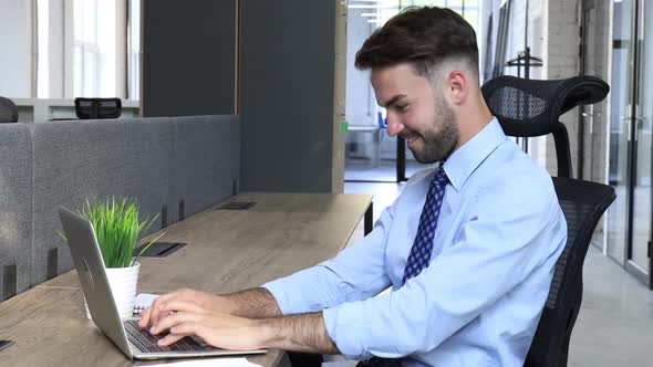 Businessman working check corporate business paper and feels overjoyed looks at laptop