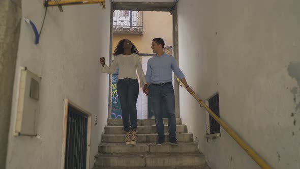Cheerful Multiracial Couple Walking Downstairs