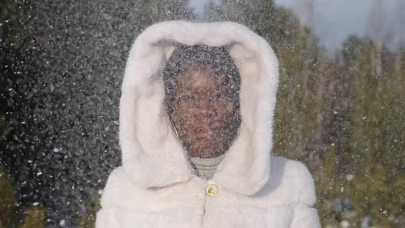AfricanAmerican Woman Poses and Smiles Under Sparkling Snow