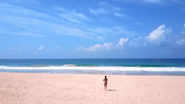 Sporty Asian Woman Run to Ocean Beach Bikini