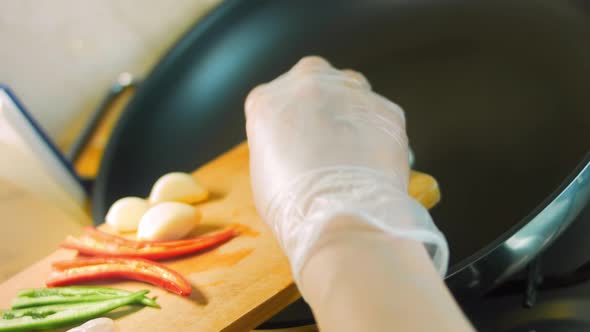 The Cook Frys Vegetables According to the Recipe Written in the Notebook