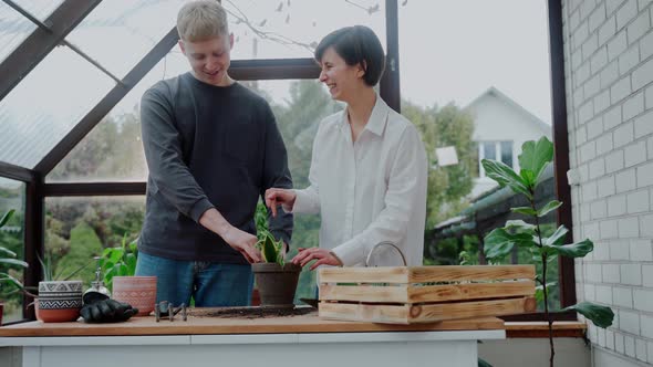 Man and Woman Doing Gardening on Terrace Having Fun