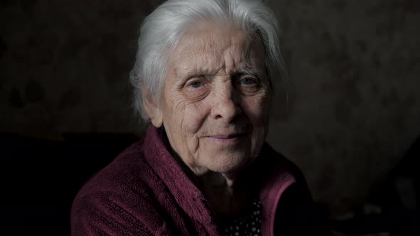 Portrait Of Very Old Elderly Caucasian Woman With Gray Hair And A Wrinkled Face