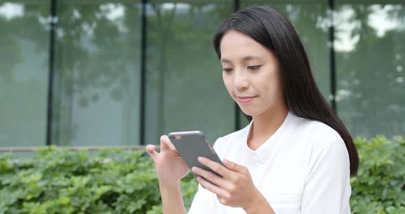 Young Woman use of smart phone in city