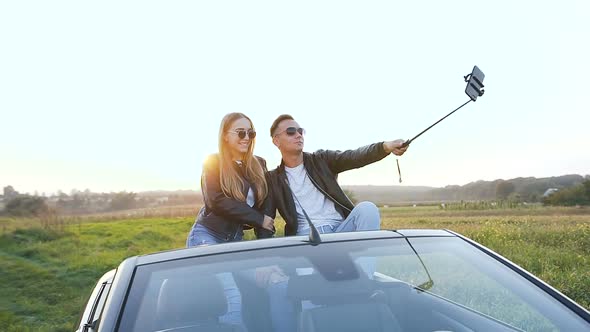 Attractive Man and Woman Taking Selfie While Sitting in the Cabriolet