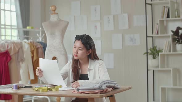 Asian Female Fashion Designer Working At Fashion Design Studio