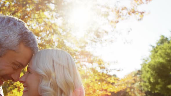 Man and woman touching noses outdoors