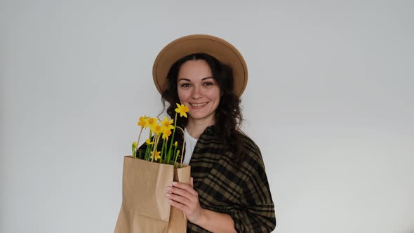 Female Florist in Shirt and Hat with Flower Paper Bag on White Background