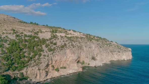 Aerial view of high hill shore and calm sea water