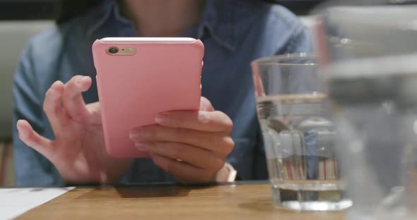 Woman use of smart phone in restaurant