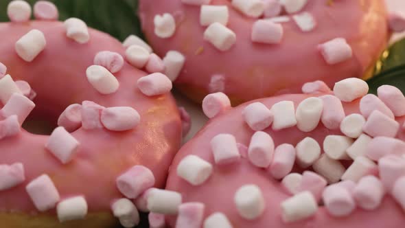 Rotating Close-up Shot of Tasty Delicious Sweet Buns Donuts With Colorful Icing and Sprinkles