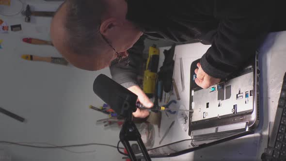 a Man Repairing a Laptop