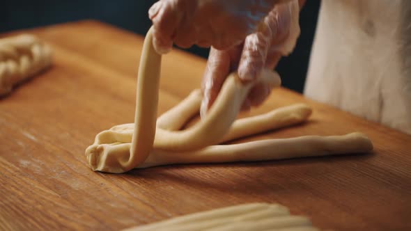 Woman making a bagel pastry with her hands