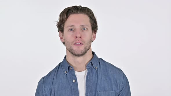 Excited Young Man Celebrating Success on White Background 