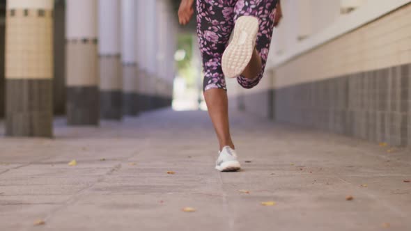 Rear view of african american woman running in the corridor