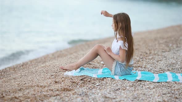 Cute Little Girl at Beach During Summer Vacation