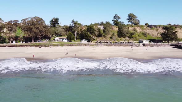 Foamy seawater hitting Seacliff State Beach in California. Aerial view