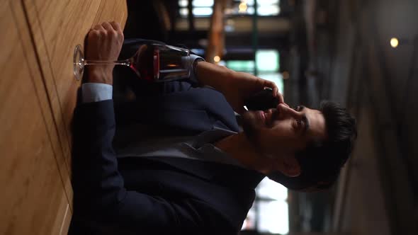 Vertical Portrait of Handsome Positive Young Man in Suit Dialing Phone Number of Girlfriends Who