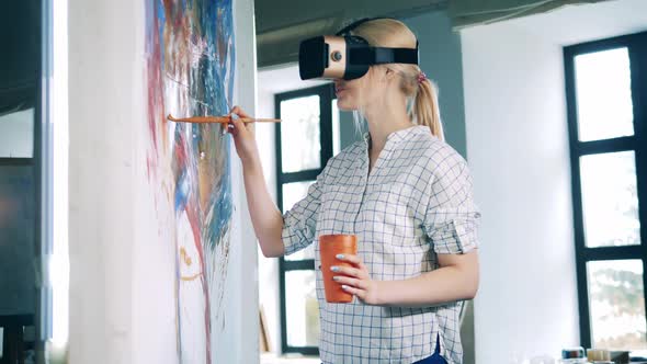 A Lady in VRglasses Is Using a Brush While Painting