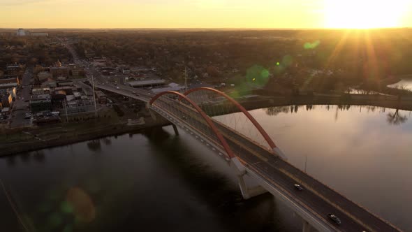Orbiting aerial view of Hastings Bridge over Mississippi River, as the sun hits the distant horizon
