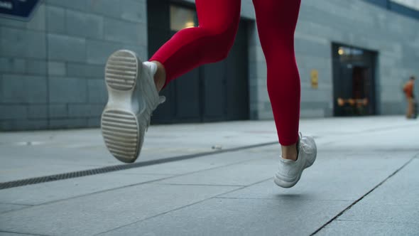 Close Up Female Legs Jogging on Urban Street. Athlete Woman Legs Running Outdoor