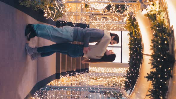 night waltz - young couple tries waltz steps among the christmas lights