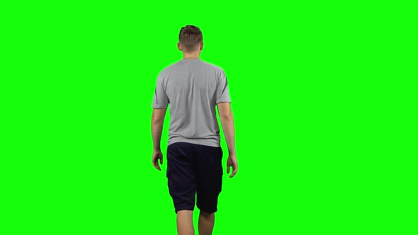 Back View of Man Walking and Greeting on a Green Screen, Chroma Key