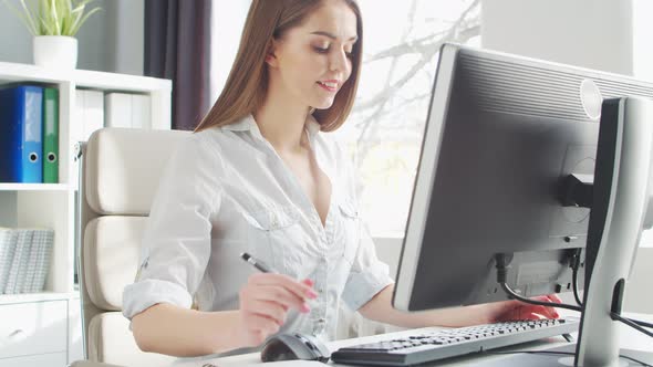 Young Woman Works at Home Office Using Computer.