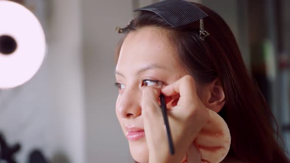 Young asian woman in bedroom. Make-up artist in beauty studio