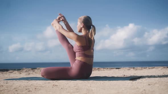 Woman Does Yoga Exercises, Stretches at Morning with View on Ocean, Slow Motion