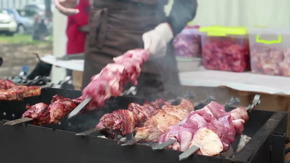 Chef Prepares Kebabs on the Grill on Festival of Street Food