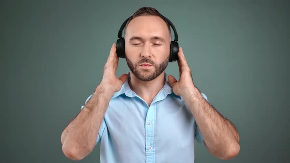 Portrait of Man Listen Music in Earphones Rejoicing Isolated