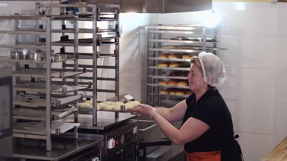 The Cook Is Taking Out the Ready Made Shaped Pastry for Donuts