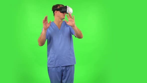 Medical Man with Virtual Reality Headset or 3d Glasses. Green Screen