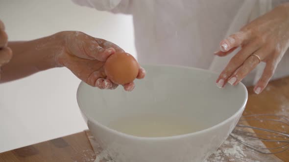 Close-up View of the Hands of Young Female Loving Couple Cook Pancakes or Breakfast in the Kitchen