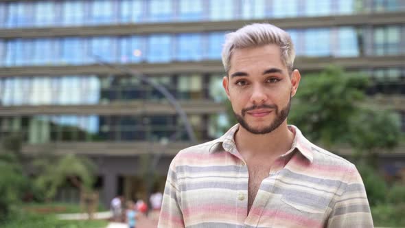 Portrait of Confident Young Gay Man with Eye Makeup Walking in the City