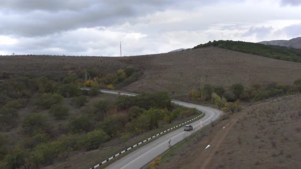 Aerial Landscape Suv Car Driving on Serpentine Asphalt Road on Hills and Mountain Background