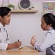 Doctor and patient sitting and discussing health examination results - VideoHive Item for Sale