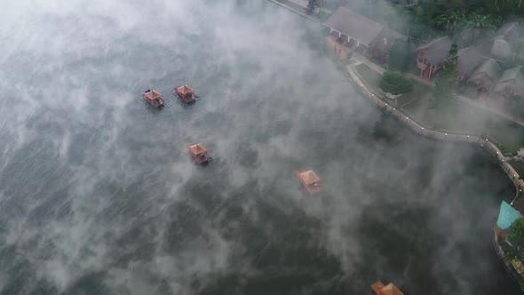 Aerial View of Sunrise with Fog Over Ban Rak Thai Chinese Village Near a Lake in Mae Hong Son