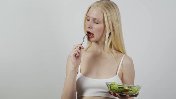 Beautiful Young Woman Eating Salad
